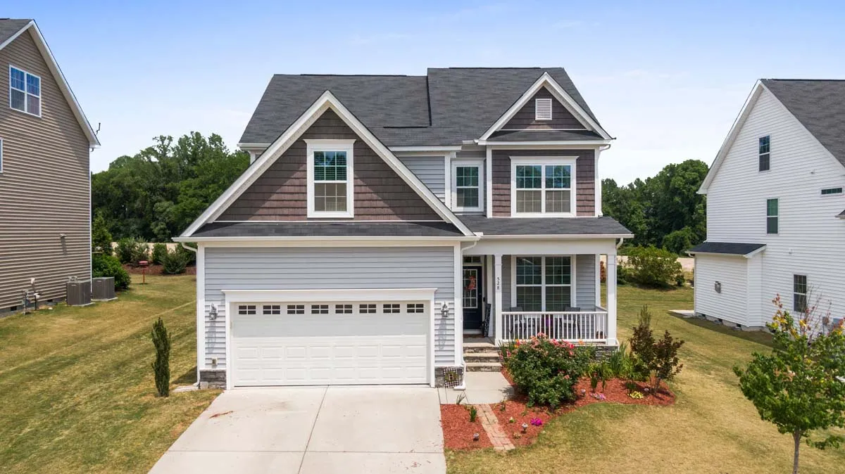 A rural house with wood-shingle siding