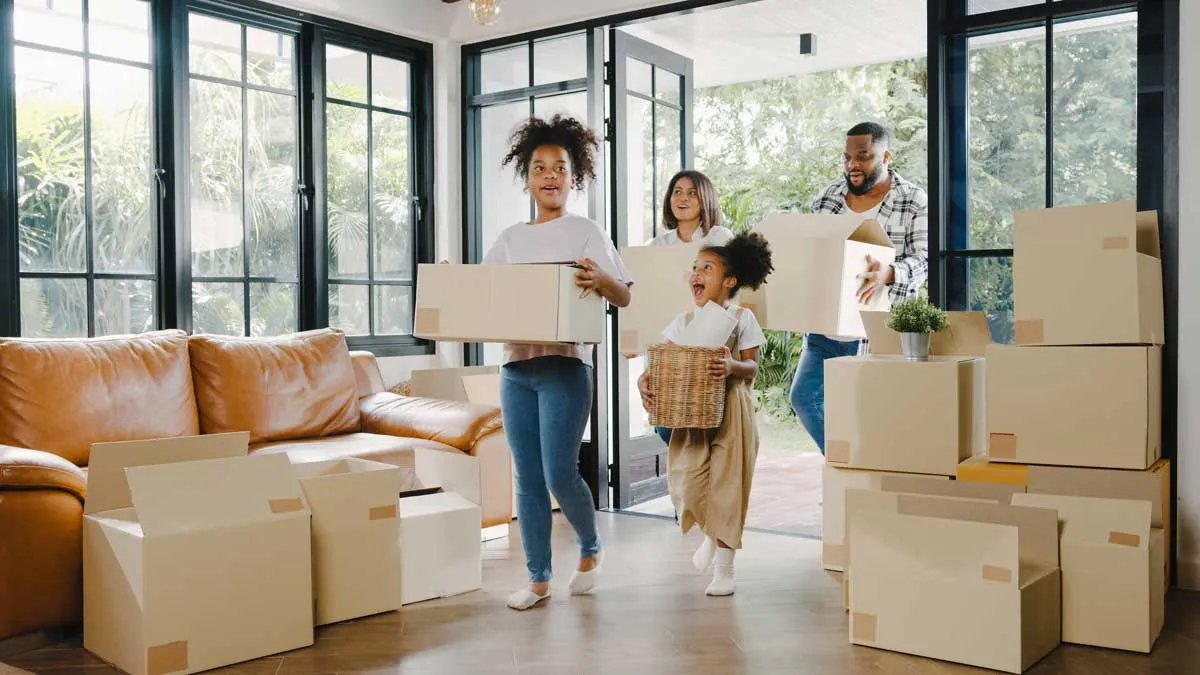 A family moving boxes into a home they just closed on