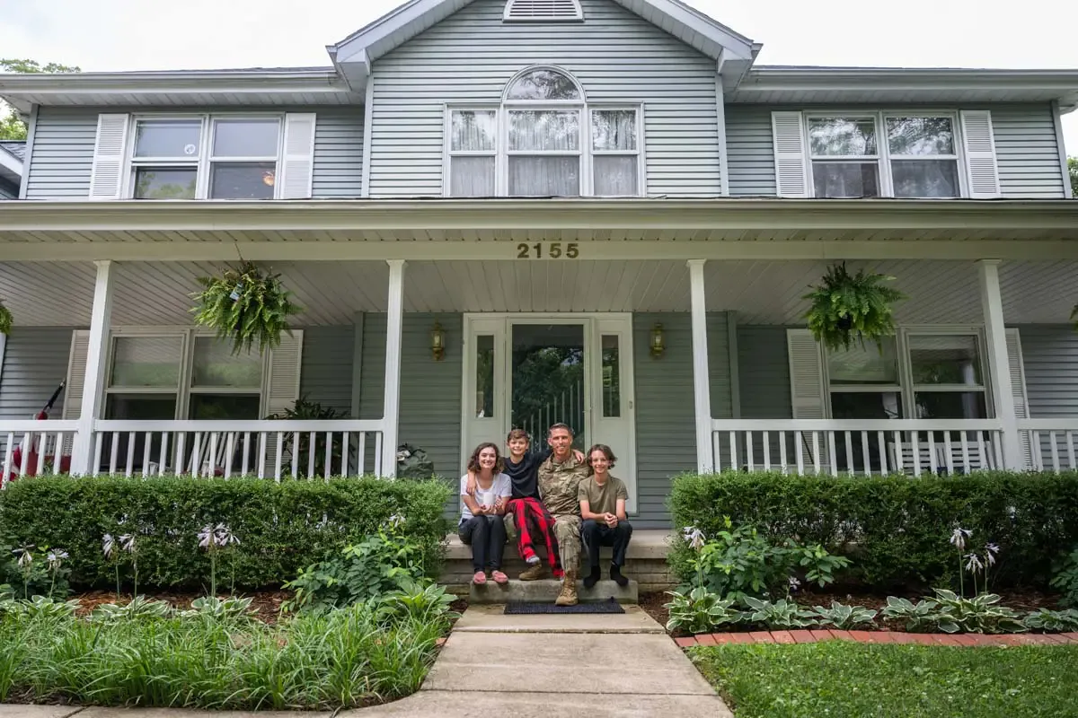 A family gathered on the porch of their home