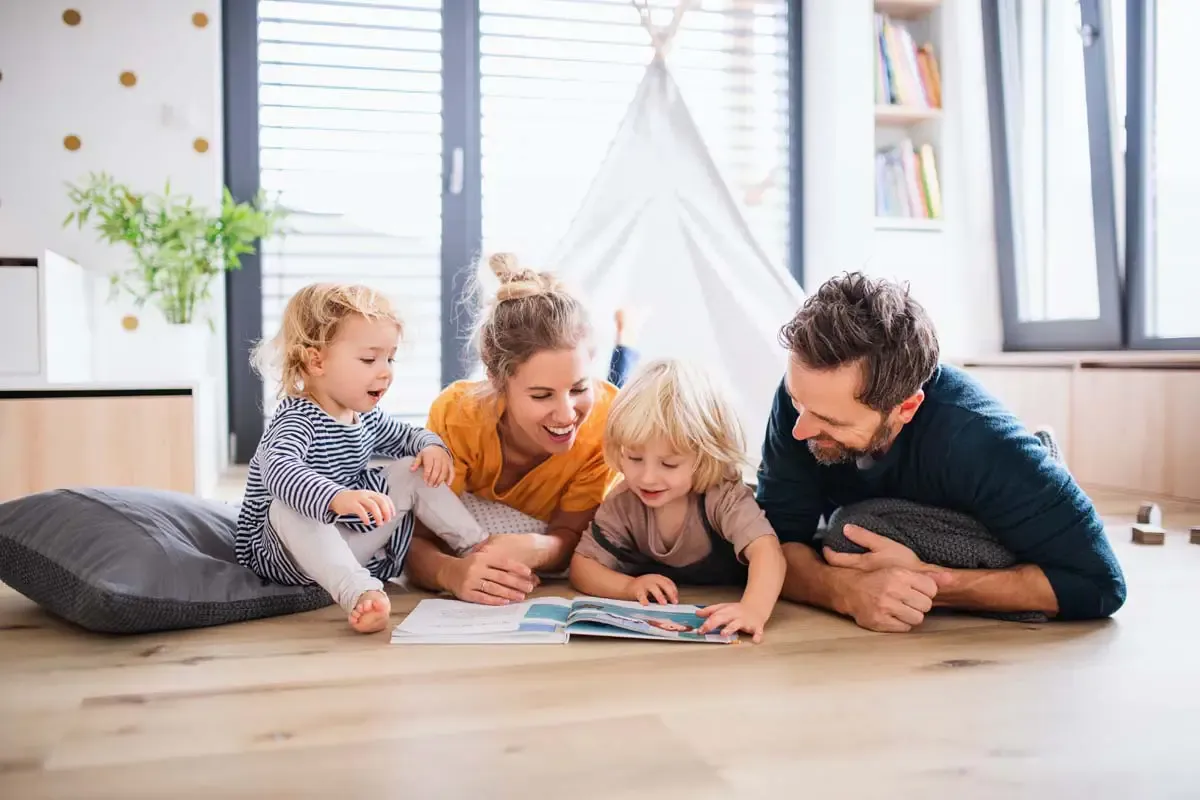A family at home reading together