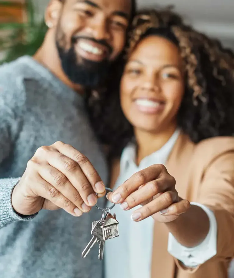 First-time buyers holding keys to their home