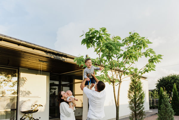 Young family in the backyard of their home