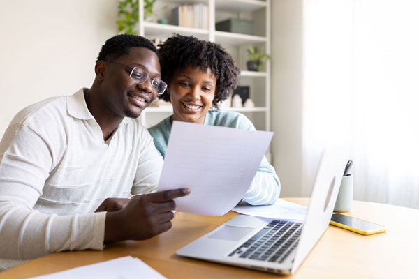 Homeowners reviewing documents together at the table